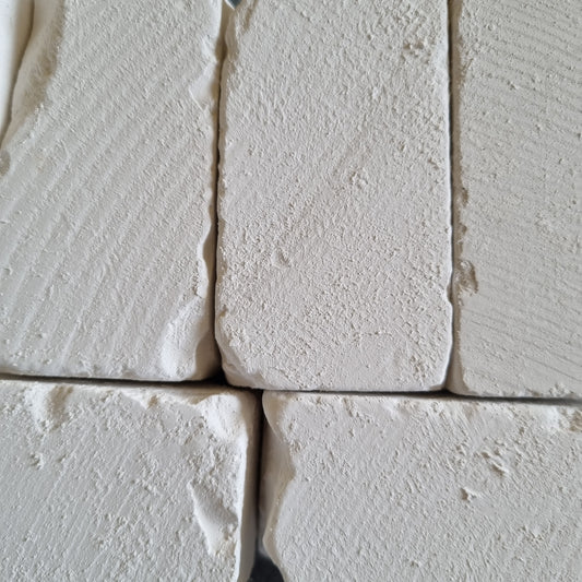 White Dobryj chalk blocks arranged side by side, showing their textured surfaces