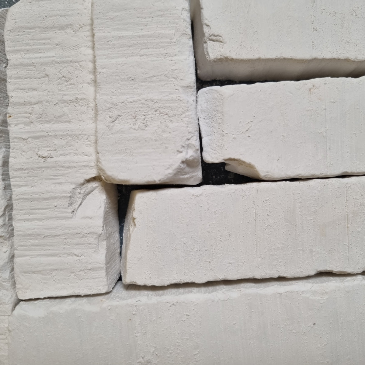 Vatutin natural white chalk pieces arranged side by side, showing flat surfaces and chipped corners.