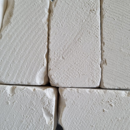 White Dobryj chalk blocks arranged side by side, showing their textured surfaces