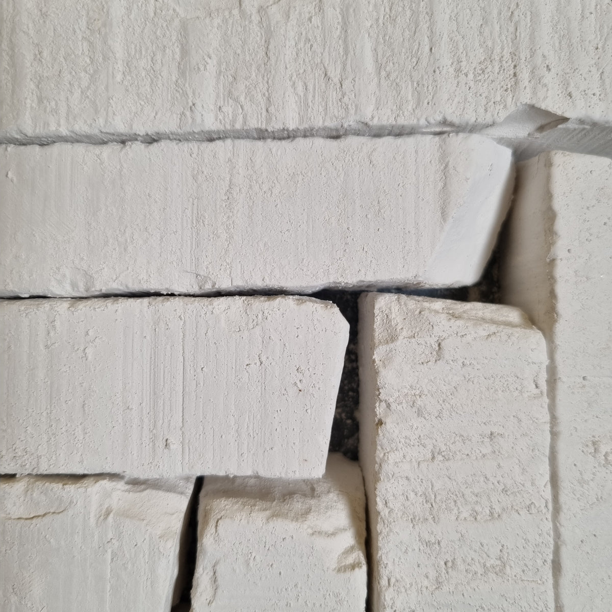 New Oskol natural white chalk pieces of different sizes with rough textures and chipped corners.
