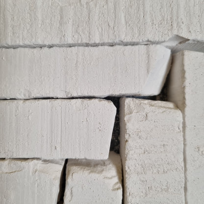 New Oskol natural white chalk pieces of different sizes with rough textures and chipped corners.