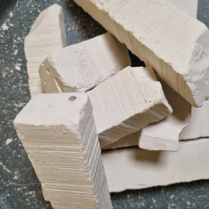 Stacked pieces of Vatutin natural white chalk with visible surface ridges and rough broken edges.