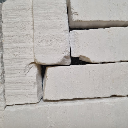 Vatutin natural white chalk pieces arranged side by side, showing flat surfaces and chipped corners.